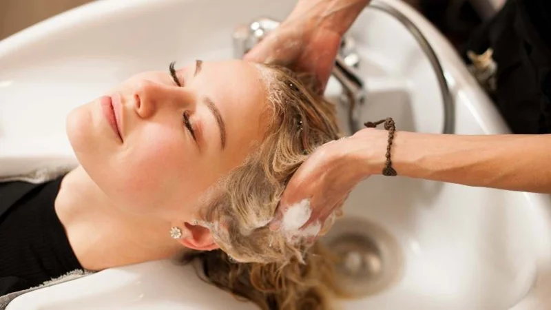 Hair being washed at a salon basin